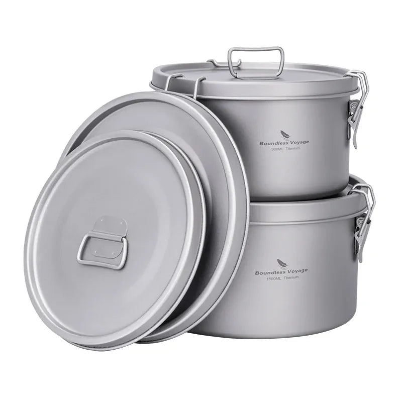 Set of titanium metal pots with lids on a white background