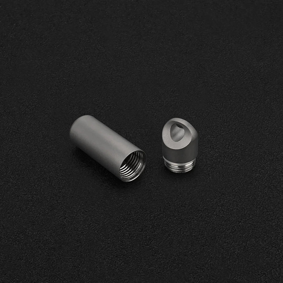 Two metallic objects on a black textured background