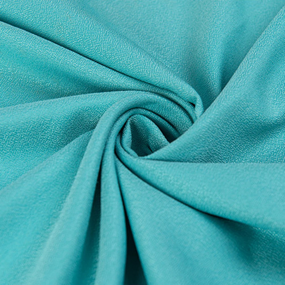 Close-up of teal fabric with folds