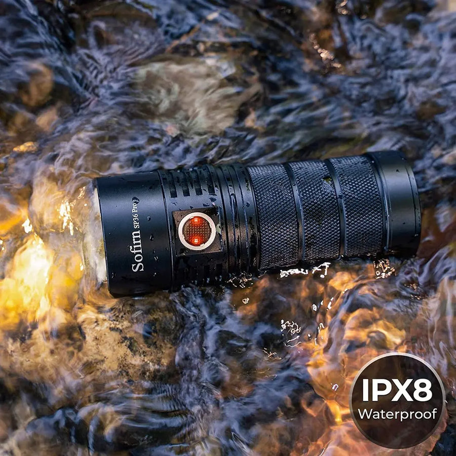 Black flashlight with IPX8 waterproof label submerged in water