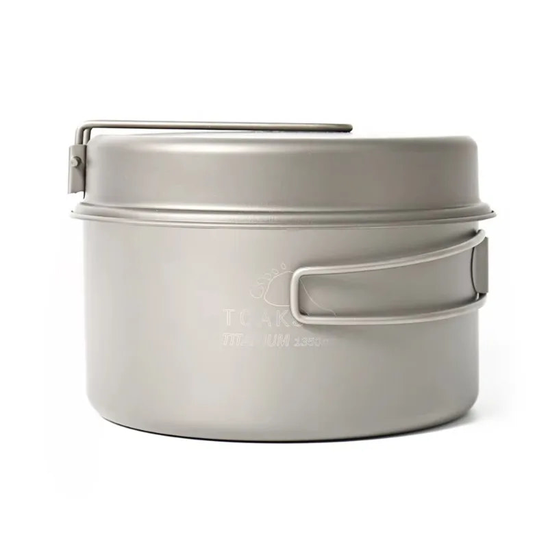 Metal camping pot with lid on a white background