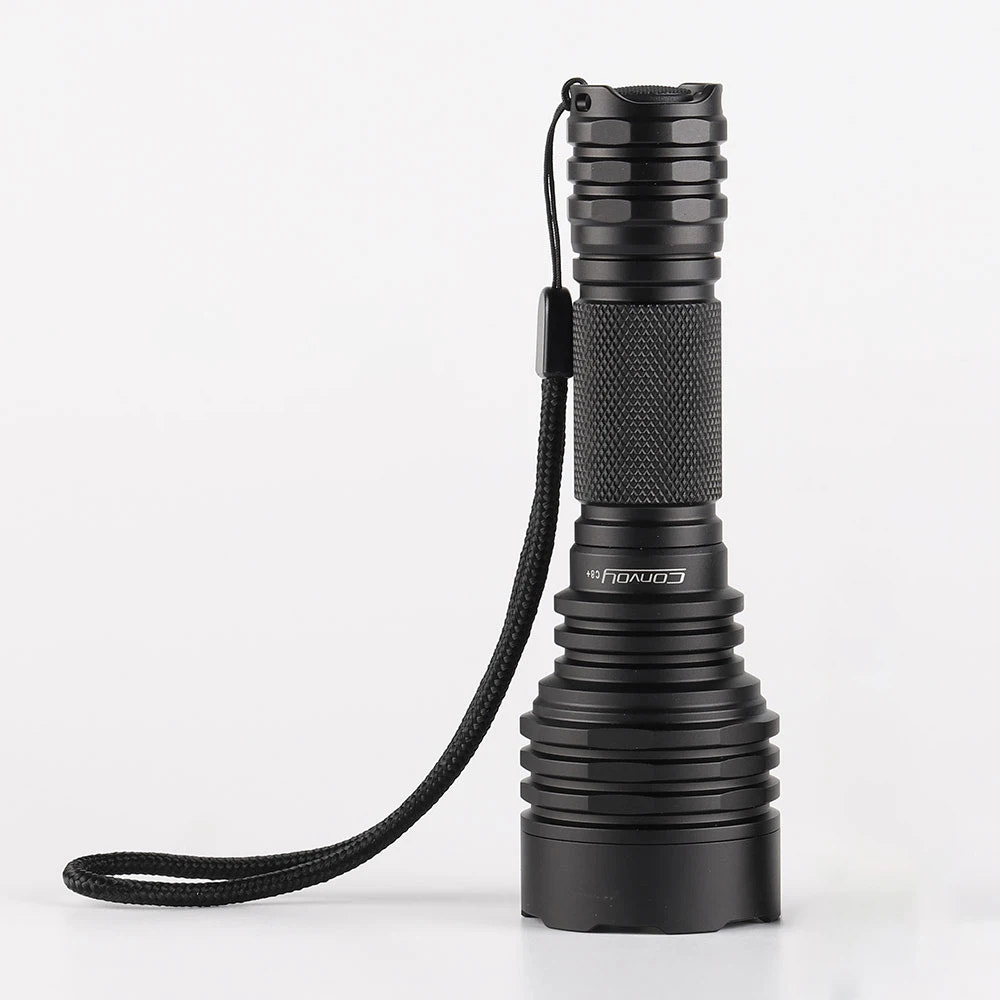 Black flashlight with a rope on a white background