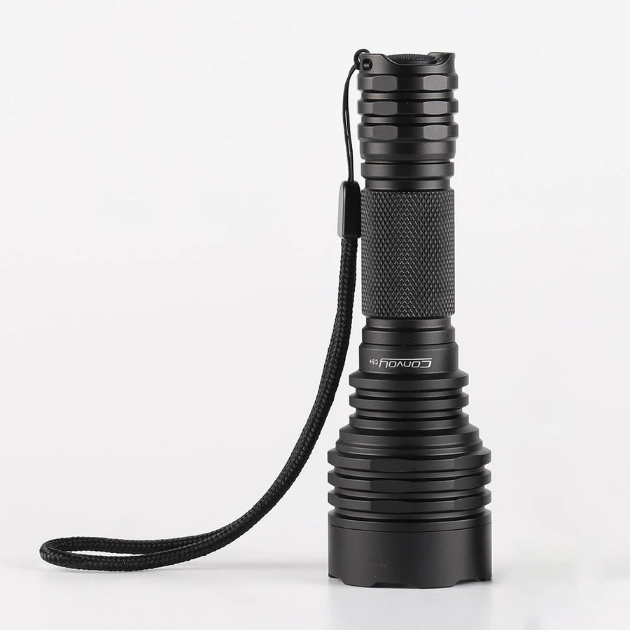 Black flashlight with a rope on a white background