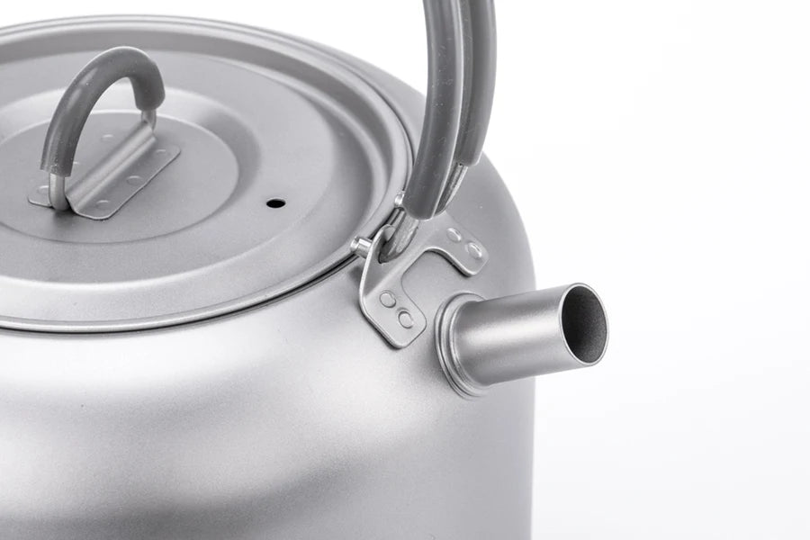 Close-up of a metal kettle with a white background