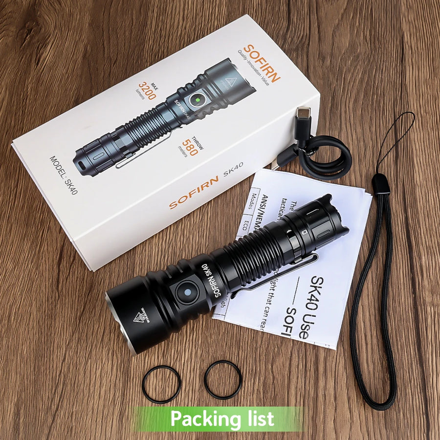 SOFIRN SK40 flashlight with packaging, USB cable, and accessories on a wooden surface