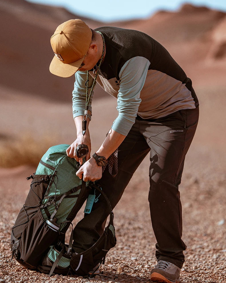 Person in desert setting preparing a backpack
