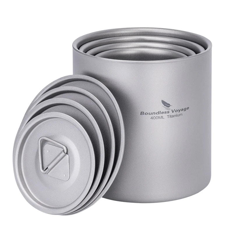 Set of gray titanium cookware with lids on a white background, featuring 'Boundless Voyage' branding.