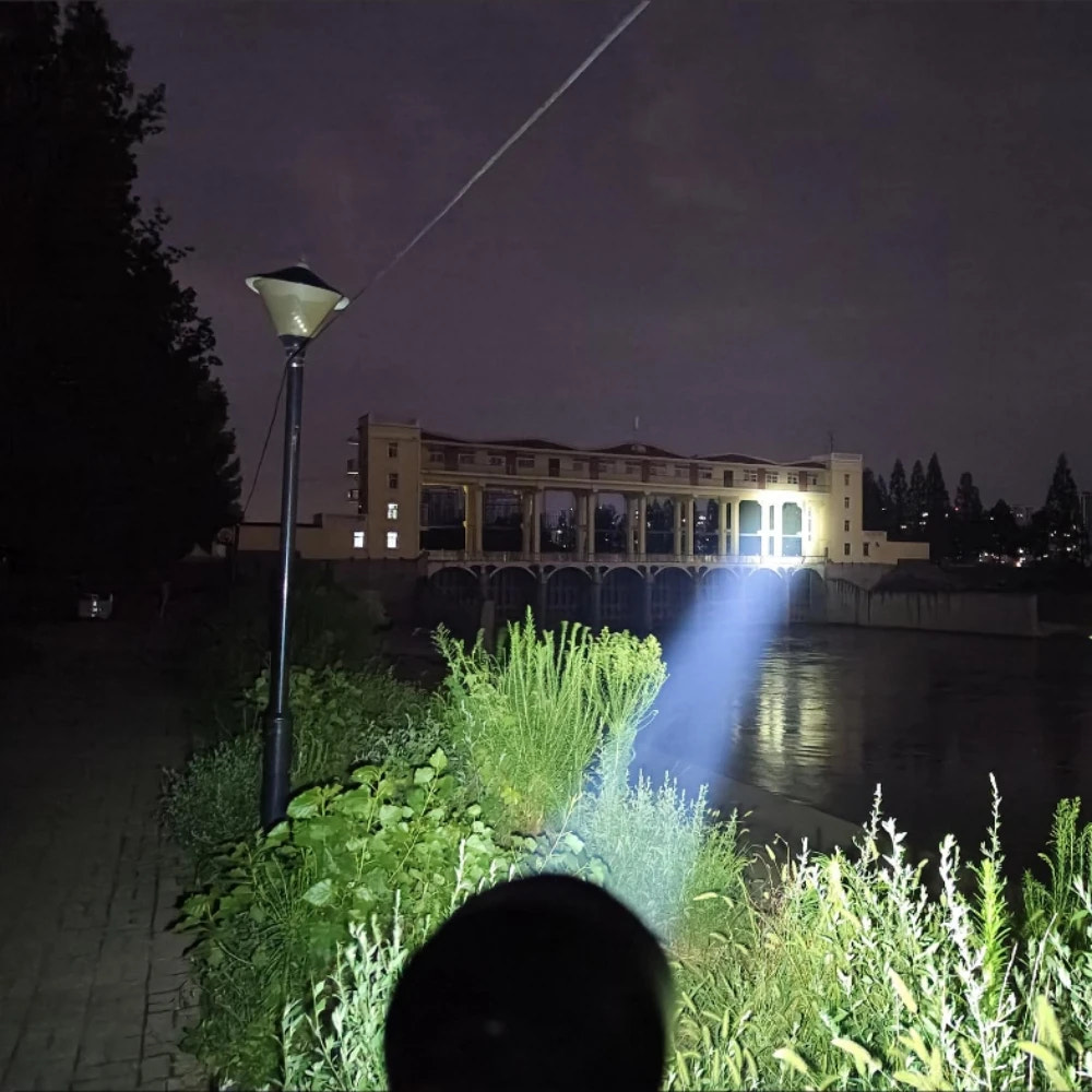 Person using a flashlight to illuminate a building at night