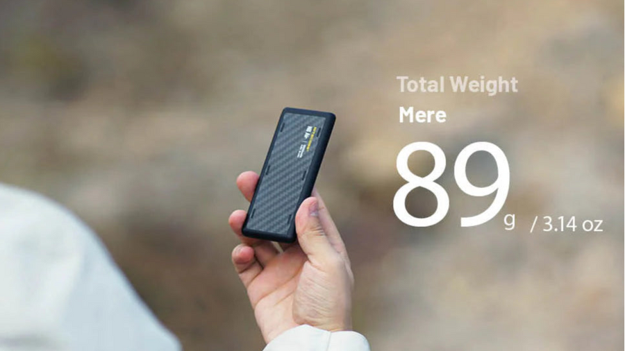 Hand holding a power bank with weight information displayed